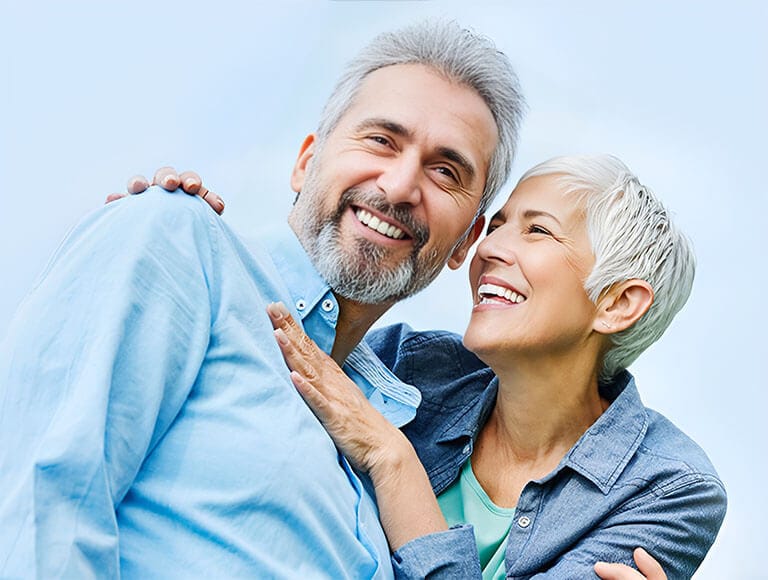 Smiling senior couple embracing outdoors