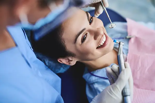 A woman smiling at a crown consultation at Highridge Dental Care