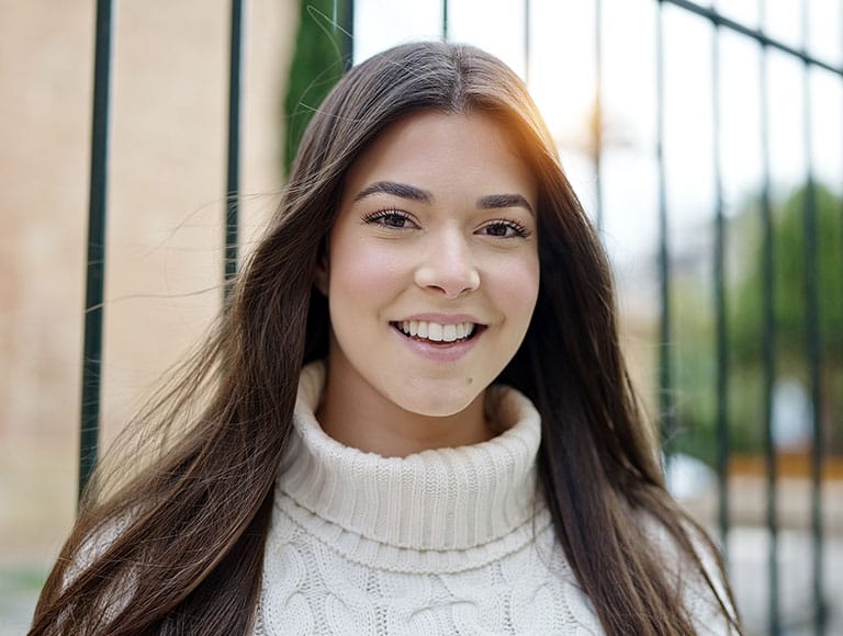 Patient smiling confidently outdoors