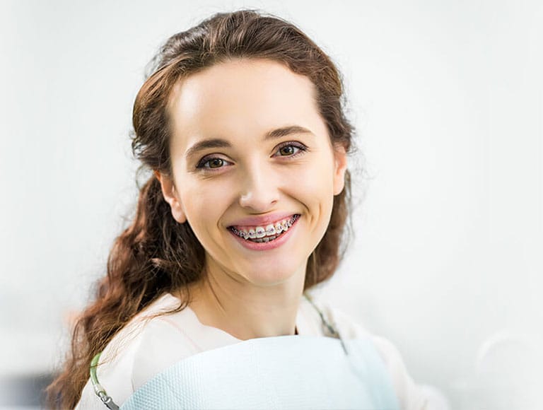 Patient with orthodontic braces smiling